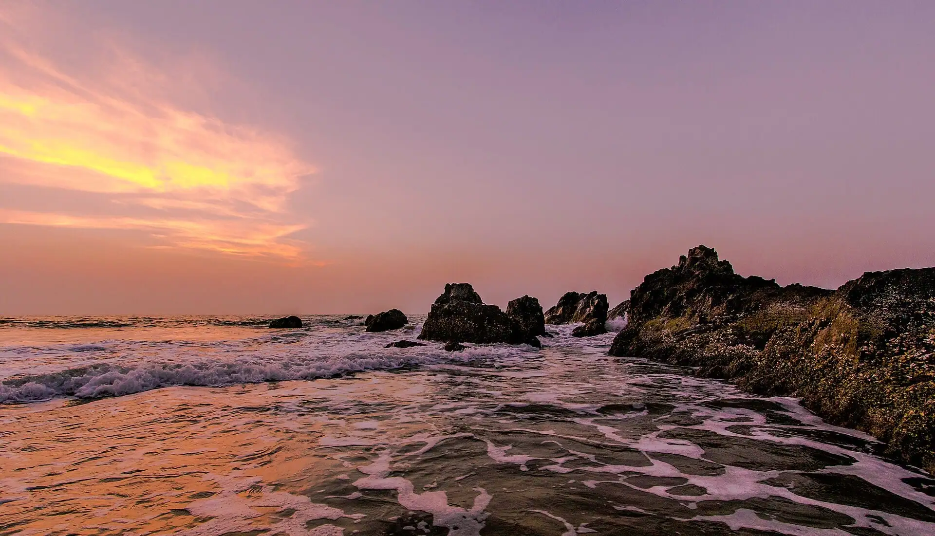 The Arabian Sea at dusk over the rocks of Dona Paula